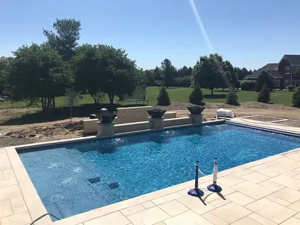 Pool with a raised stone water-feature wall