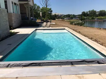 Pool build on a waterfront property with tanning-ledge steps