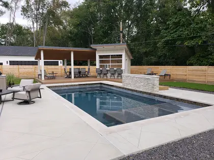 Custom pool with covered outdoor bar and lounge pavilion built by Mud Slingers