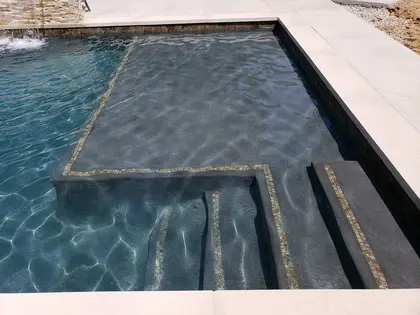 Tanning ledge and in-pool seating with mosaic tile trim