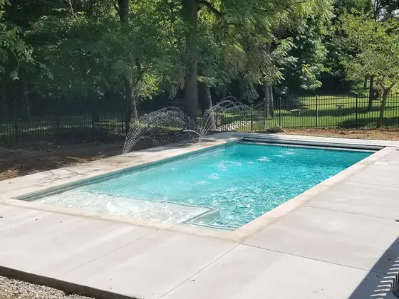 In-ground pool patio and decking by Mud Slingers