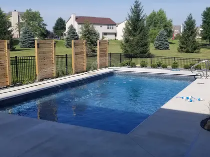 Finished pool with automatic safety cover and cedar privacy screening